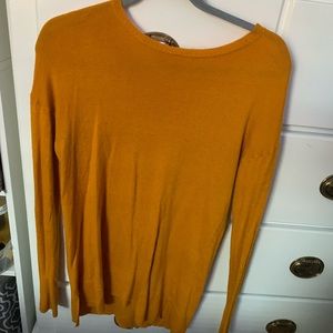 mustard yellow sweater.